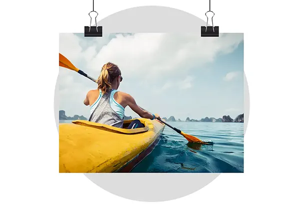 A poster print showing a woman kayaking on a peaceful lake, viewed from behind. Turn your best shots into beautiful wall art.