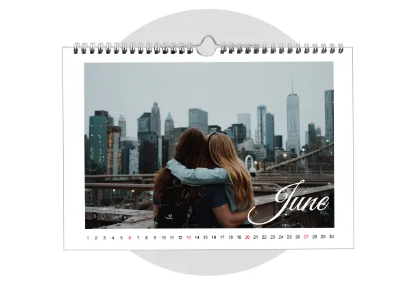 Two friends hugging with a city skyline behind them, featured on a photo calendar. Create your own wall calendar for a year full of memories.
