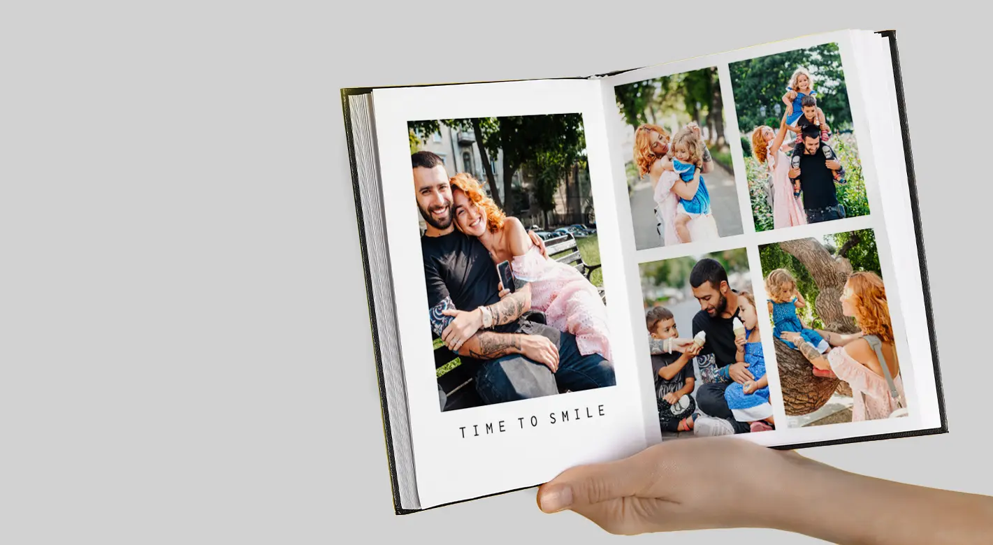 Open photo book showing a happy young family in a park with the words "Time to Smile". Capture your cherished memories in a photo book that will stand the test of time.