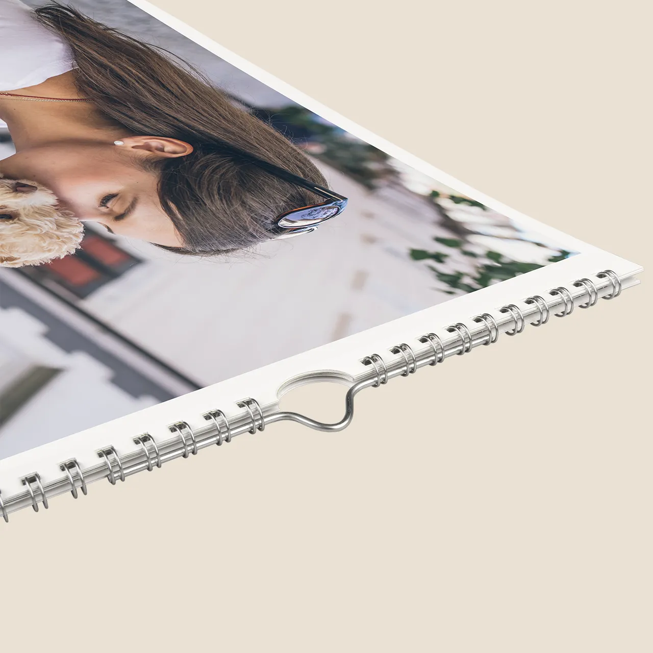 Photo calendar with metal spiral binding A close-up of a calendar printing sample highlights the quality spiral binding and professional photo finish.