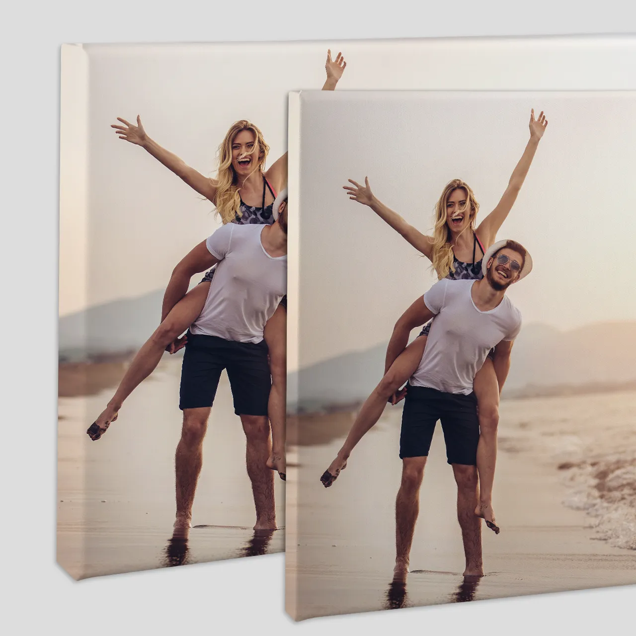 Personalised canvas print capturing fun seaside memories couple enjoying playful moment on beach printed on canvas