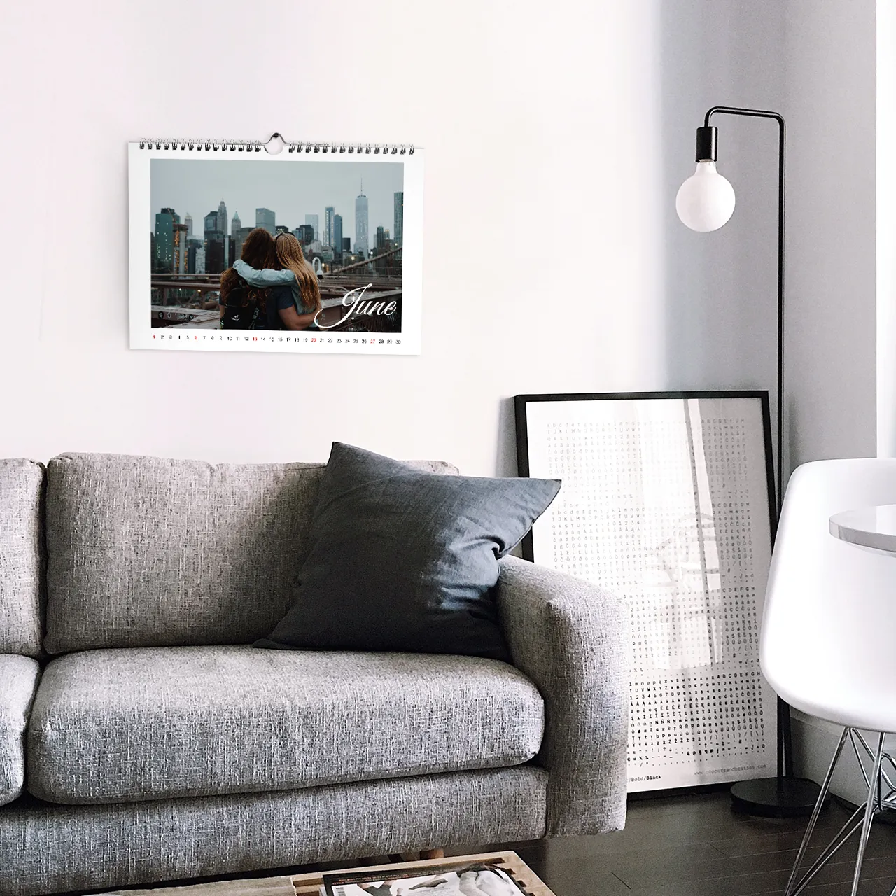 Calendar printing, many design options This personalised calendar is stylishly displayed above a grey sofa, perfect for adding charm to any living space.